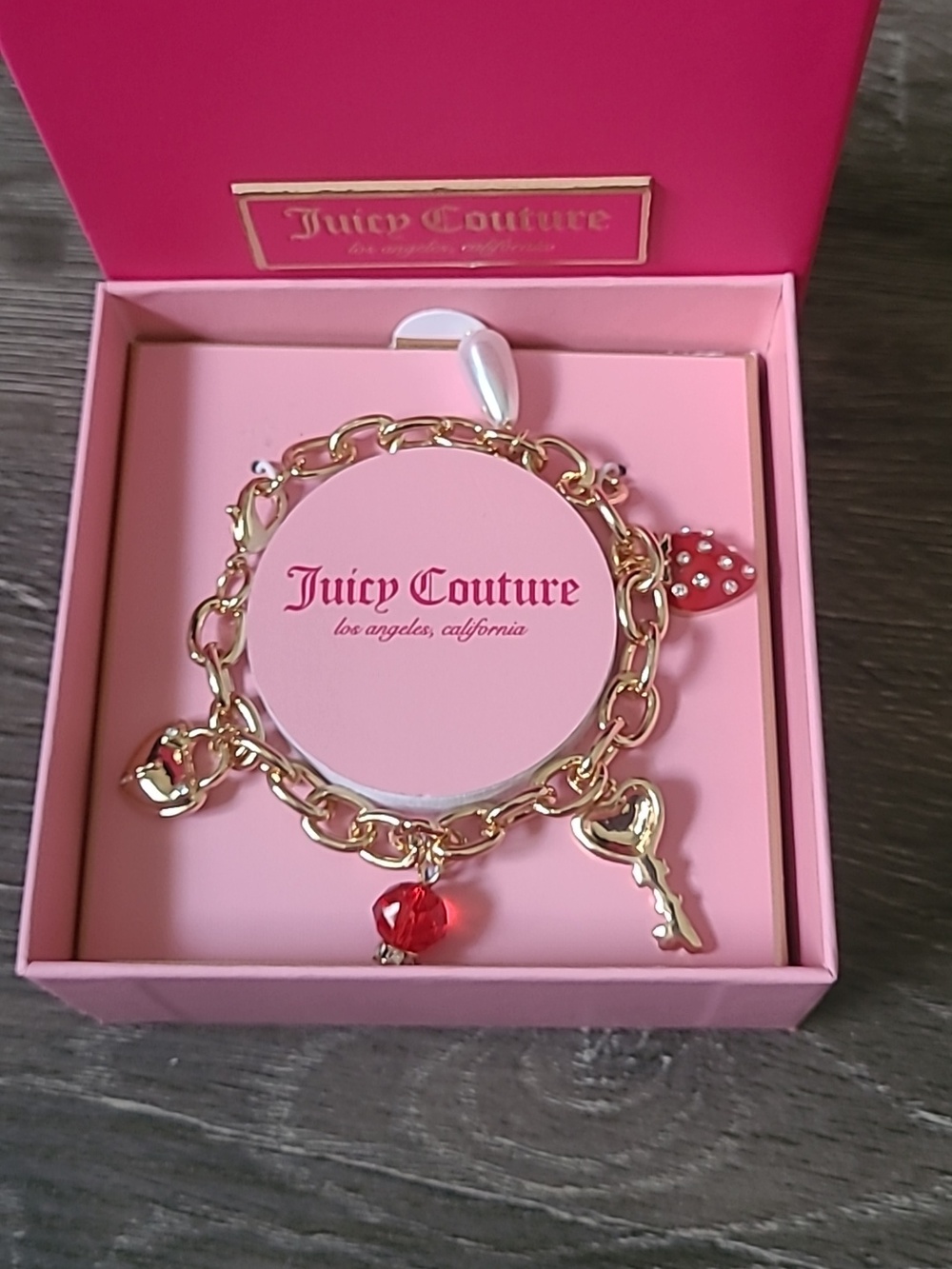 Juicy Couture Gold Charm Bracelet with Red Accents And Strawberry Charm